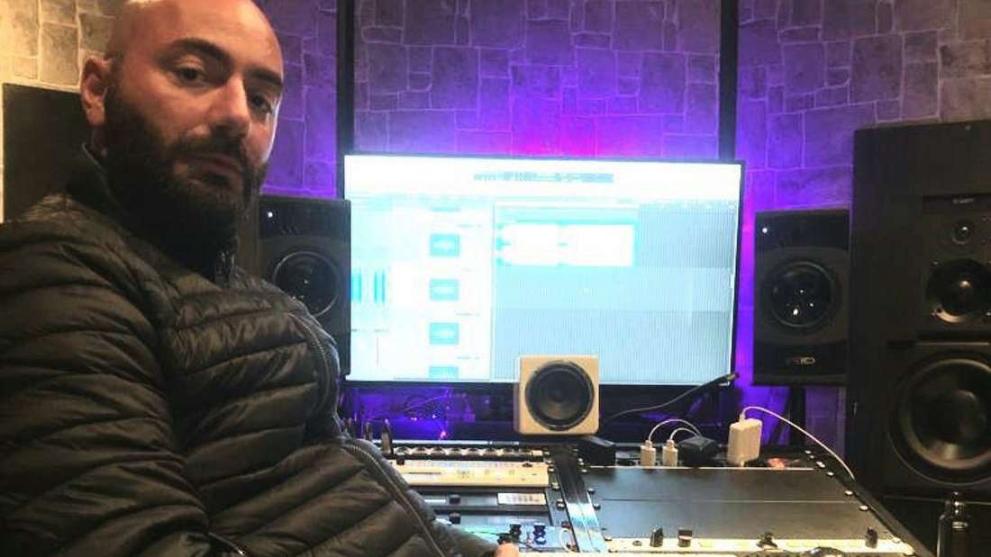 Michail Kolesidis sitzt vor einem Studio Computer und schaut in die Kamera.